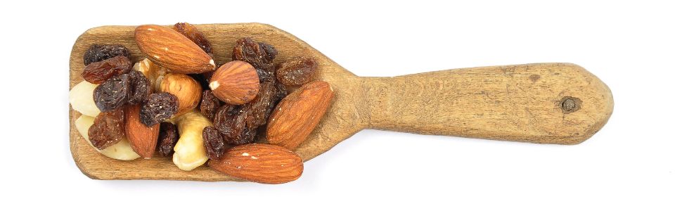 Trail mix on wooden spoon.