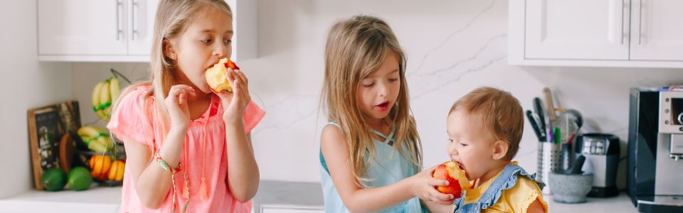 Children eating apples.