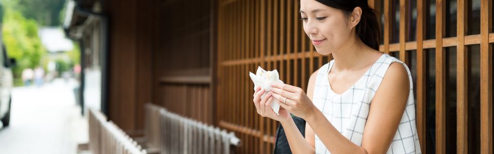 A lady enjoy eating snack.