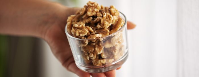 A glass cup with walnuts