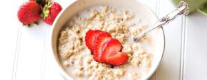A bowl of oatmeal with strawberries